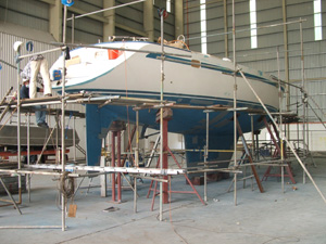 Faith, with no windows, hardware, or mast, stripped for work in Langkawi, Malaysia