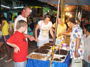 The Grangers at the bug booth at a night market in Phuket, Thailand